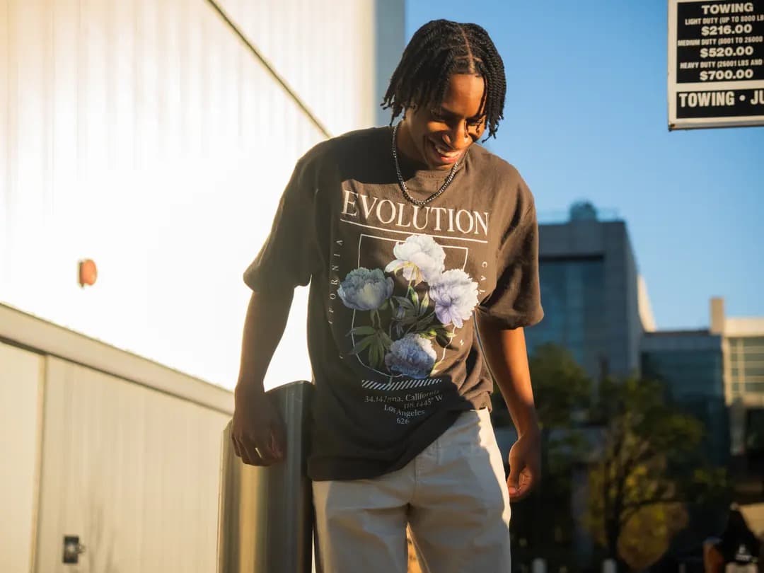 Content creation — Evolution t-shirt, outdoor golden hour, cornrows