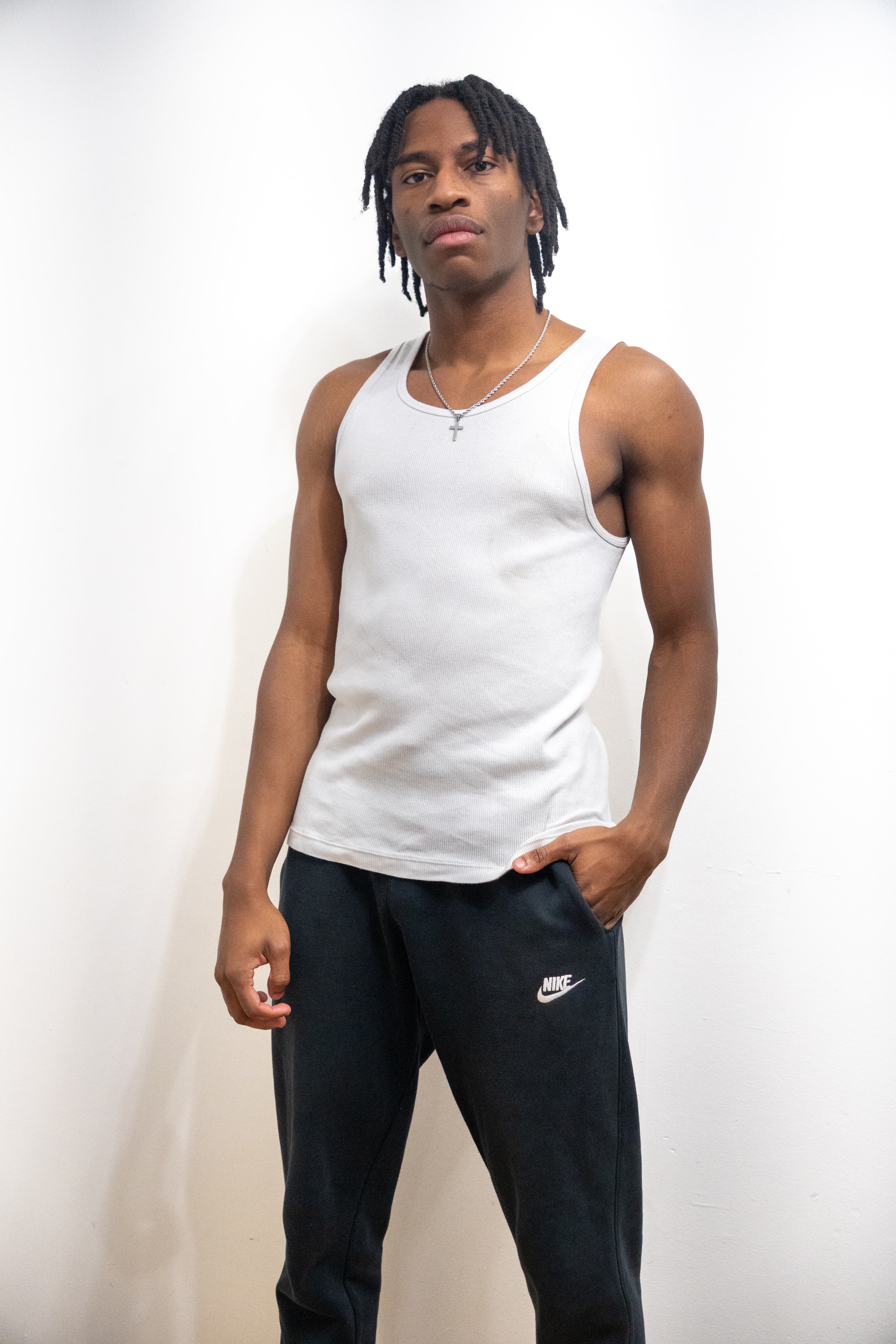 Three-quarter body — white tank, Nike sweats